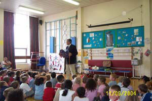 photo of Gervase Phinn in hall with children