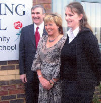 Photo shows Gervase Phinn and 2 others outside a school building